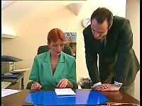 Redheaded older secretary sucks boss's cock at her desk